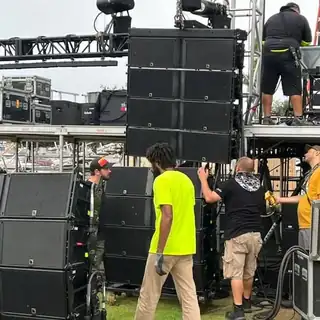Audio visual technicians setting up sound and media consoles