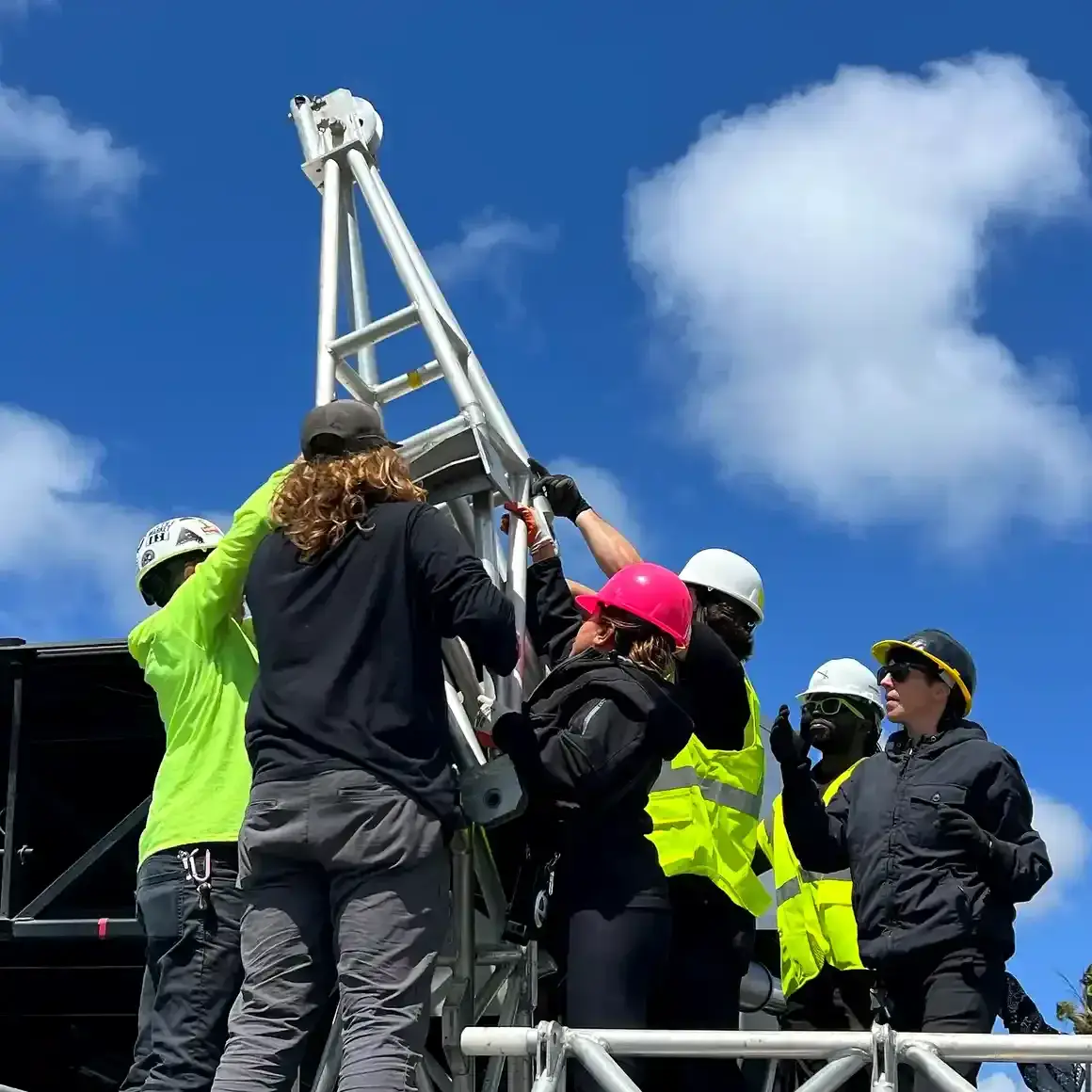 Stagehands and AV technicians setting up an event in San Diego
